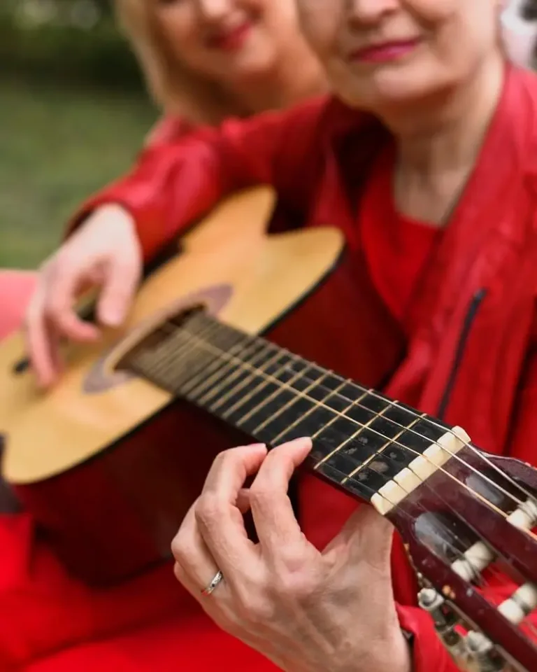 anciano tocando la guitarra en la residencia
